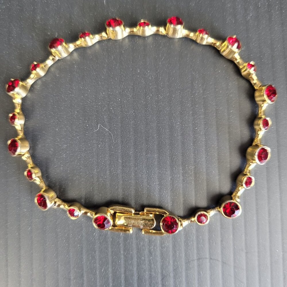 Vintage Monet gold tone bracelet with bezel set faux rubies